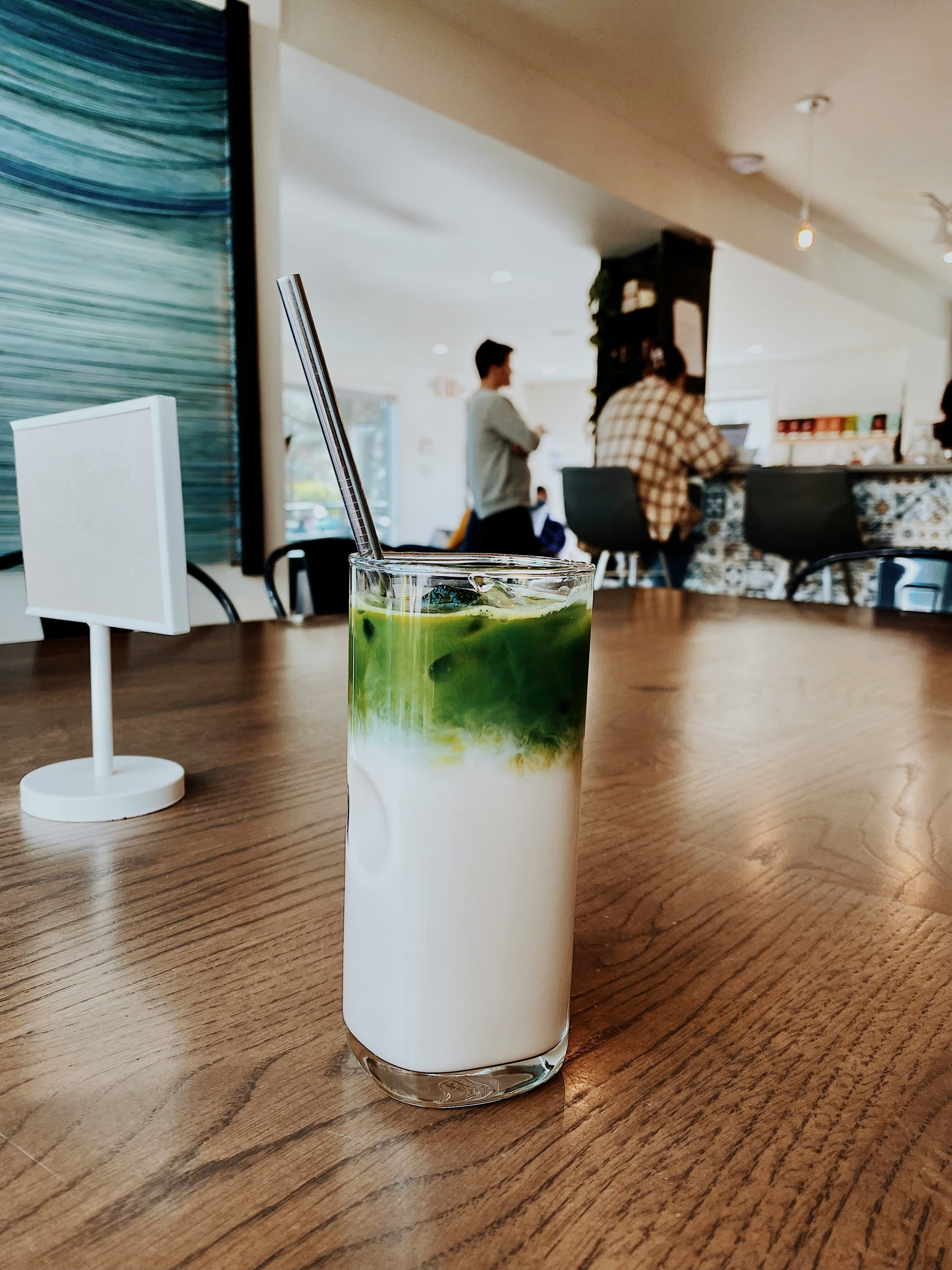 Iced matcha latte in a glass with layered green and white